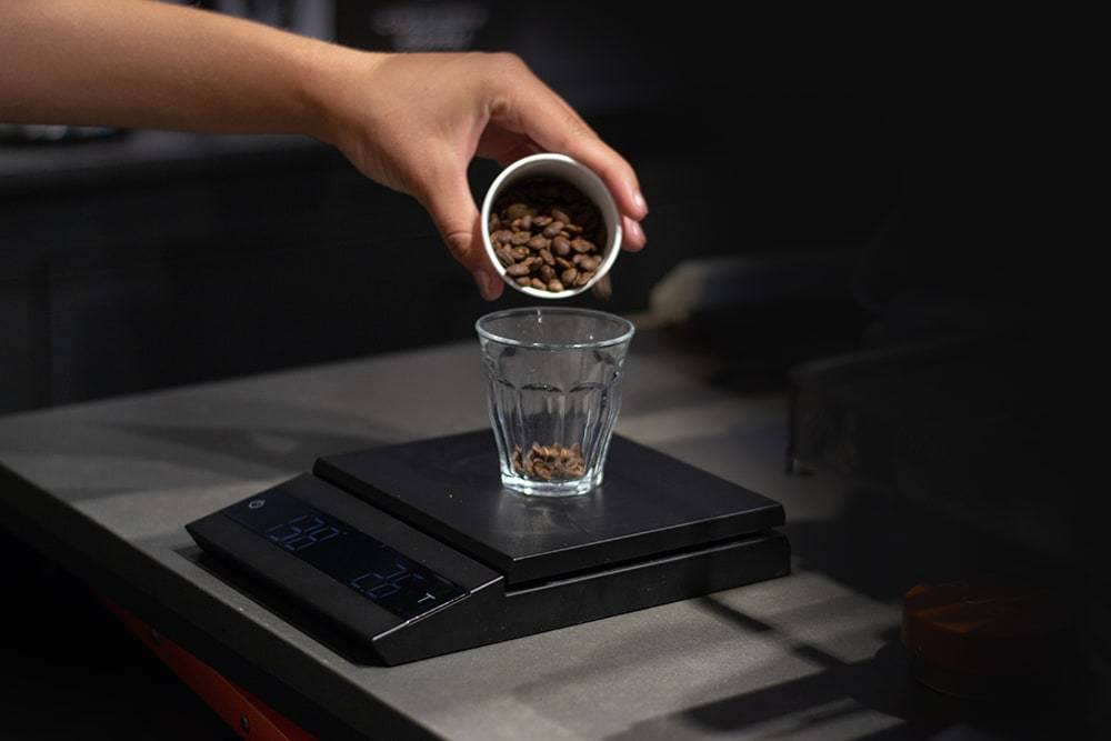 Picture of a man scaling coffee